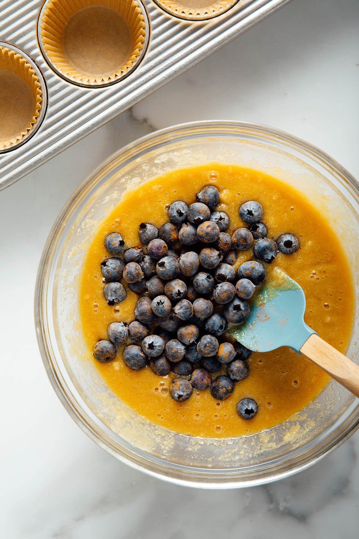 folding blueberries into batter